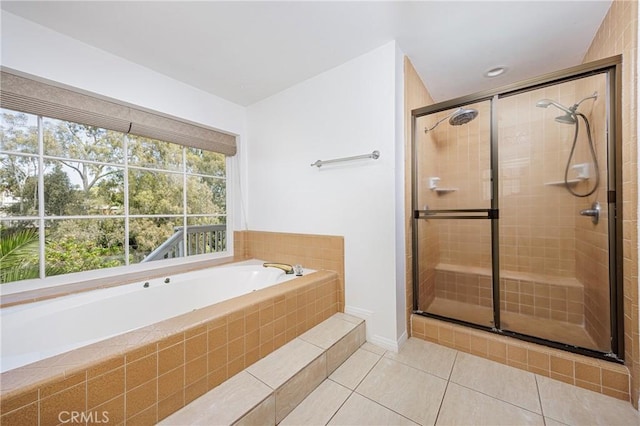bathroom with a bath, a stall shower, and tile patterned flooring