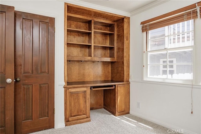 unfurnished office with light carpet, baseboards, and ornamental molding