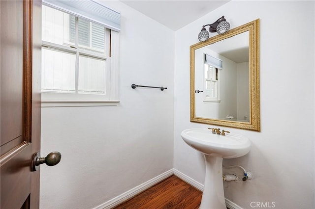 bathroom with baseboards and wood finished floors