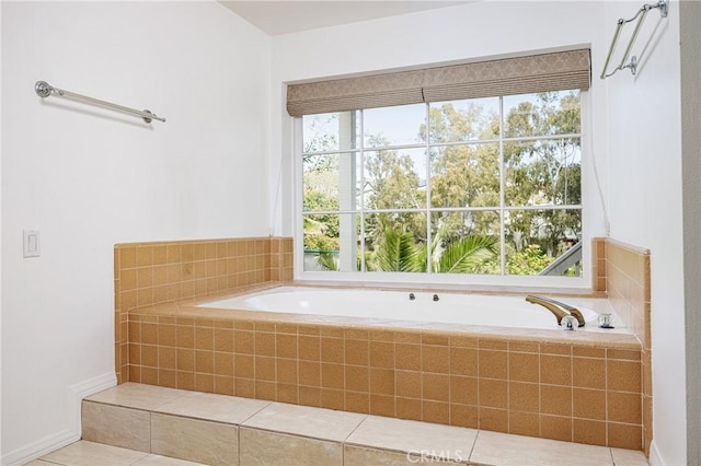 bathroom with tile patterned flooring and a garden tub