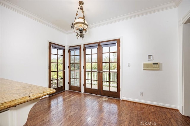 entryway featuring ornamental molding, french doors, wood-type flooring, and a notable chandelier