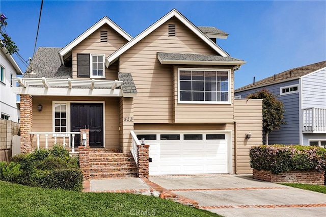 view of front of house featuring a shingled roof, a garage, and concrete driveway