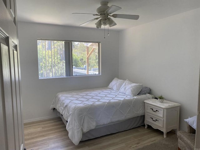 bedroom featuring a ceiling fan and wood finished floors