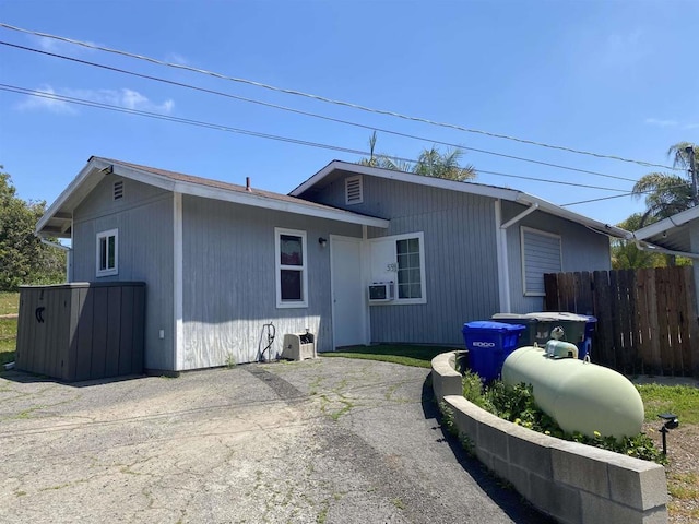 back of house featuring fence