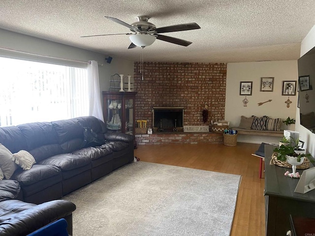 554 Taylor St, Vista, CA 92084 - living area featuring ceiling fan, a textured ceiling, wood finished floors, and a brick fireplace