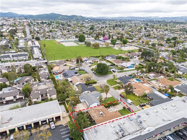 birds eye view of property featuring a mountain view and a residential view