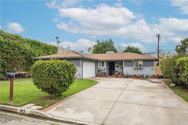 single story home with a front yard, driveway, and an attached garage