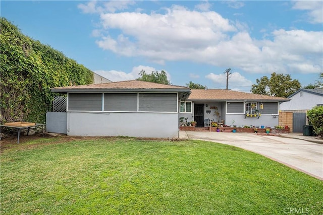 ranch-style home with a front yard and stucco siding