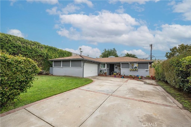 view of front of home featuring a front yard, an attached garage, concrete driveway, fence, and stucco siding