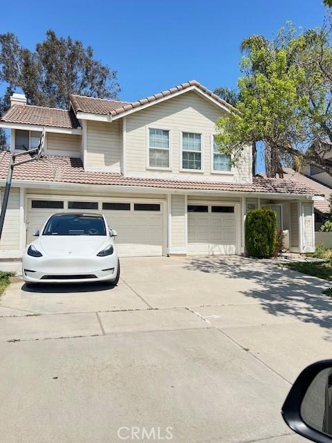 2899 Amber Dr, Corona, CA 92882 - view of front of property with an attached garage, a tile roof, and driveway