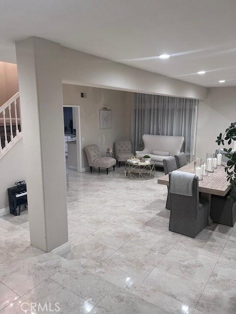 2899 Amber Dr, Corona, CA 92882 - living room with stairway, visible vents, marble finish floor, and baseboards