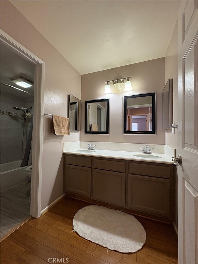 100 N Electric Ave Unit 5, Alhambra, CA 91801 - bathroom featuring double vanity, wood-type flooring, toilet, and shower / bath combo