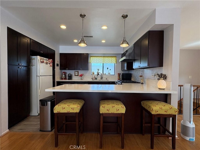 100 N Electric Ave Unit 5, Alhambra, CA 91801 - kitchen with freestanding refrigerator, light countertops, a peninsula, light wood-style flooring, and recessed lighting