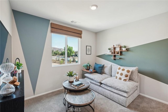 living area featuring visible vents, baseboards, and carpet floors