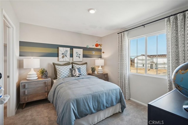 carpeted bedroom featuring baseboards