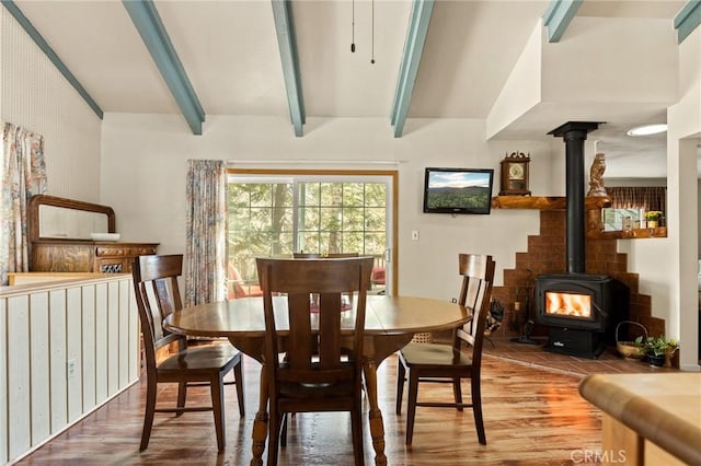 337 Lookout Dr, Twin Peaks, CA 92391 - dining space with wood finished floors, a wood stove, and beam ceiling