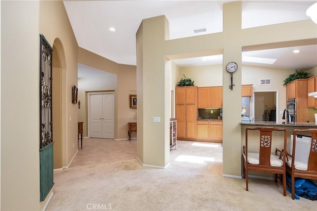 24182 Via Llano, Murrieta, CA 92562 - corridor featuring light carpet, vaulted ceiling, recessed lighting, and baseboards