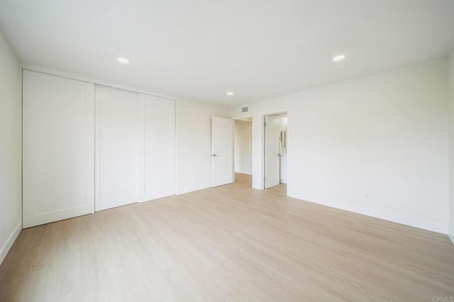 interior space with recessed lighting, light wood-type flooring, and baseboards
