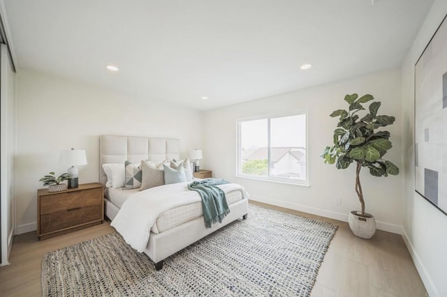 bedroom featuring recessed lighting, light wood-style floors, and baseboards