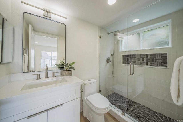 full bath with toilet, a stall shower, vanity, and recessed lighting