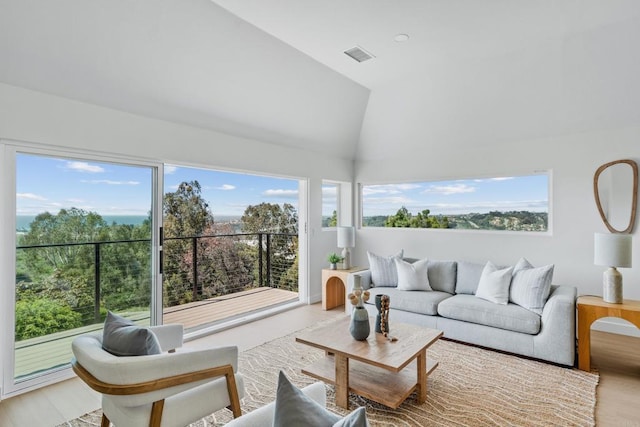 living area featuring high vaulted ceiling and visible vents