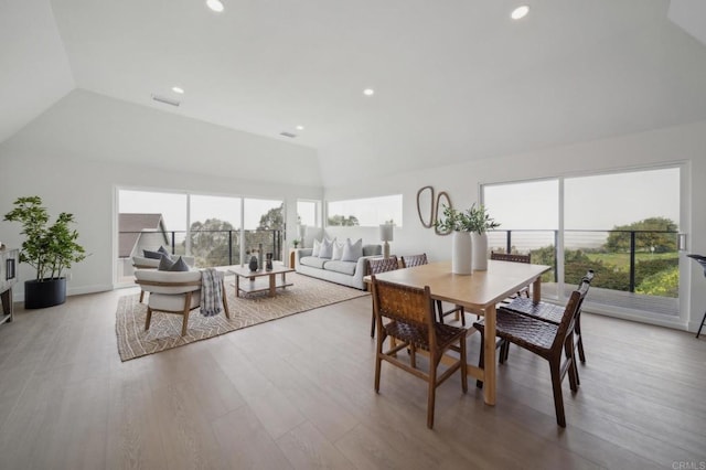 dining space with recessed lighting, baseboards, vaulted ceiling, and wood finished floors