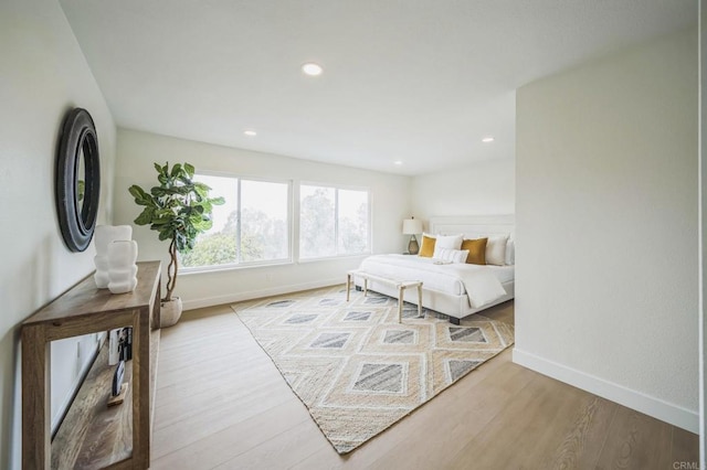 bedroom with recessed lighting, baseboards, and wood finished floors