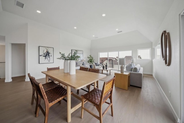 dining space with visible vents, baseboards, light wood finished floors, and recessed lighting