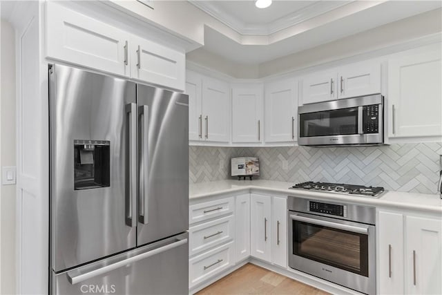 351 W Northridge Ave, Glendora, CA 91741 - kitchen with crown molding, tasteful backsplash, white cabinetry, appliances with stainless steel finishes, and light countertops