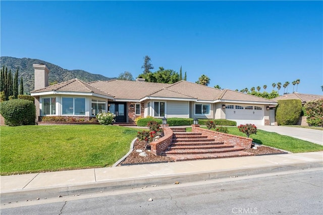 351 W Northridge Ave, Glendora, CA 91741 - ranch-style home featuring a chimney, driveway, an attached garage, a front lawn, and a tiled roof