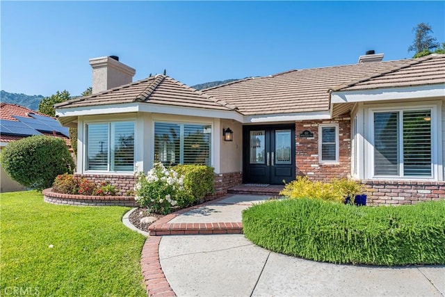 351 W Northridge Ave, Glendora, CA 91741 - entrance to property with a chimney, a yard, a tile roof, and brick siding