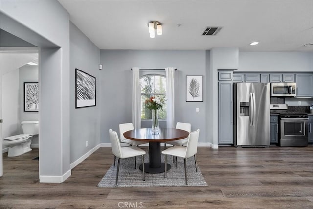 dining room featuring baseboards, dark wood-style flooring, visible vents, and recessed lighting