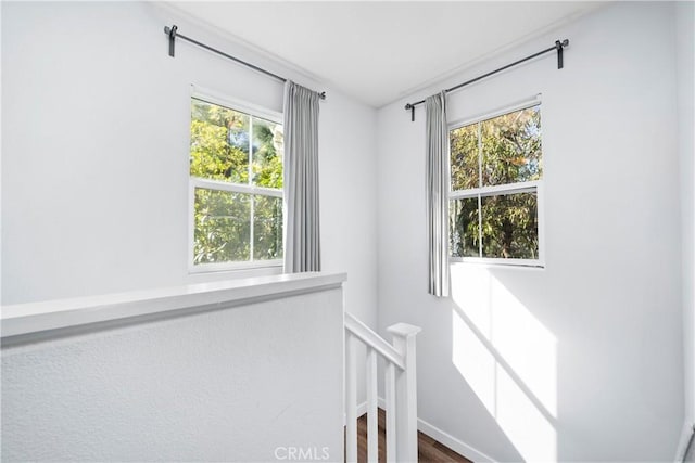 stairway featuring wood finished floors and baseboards