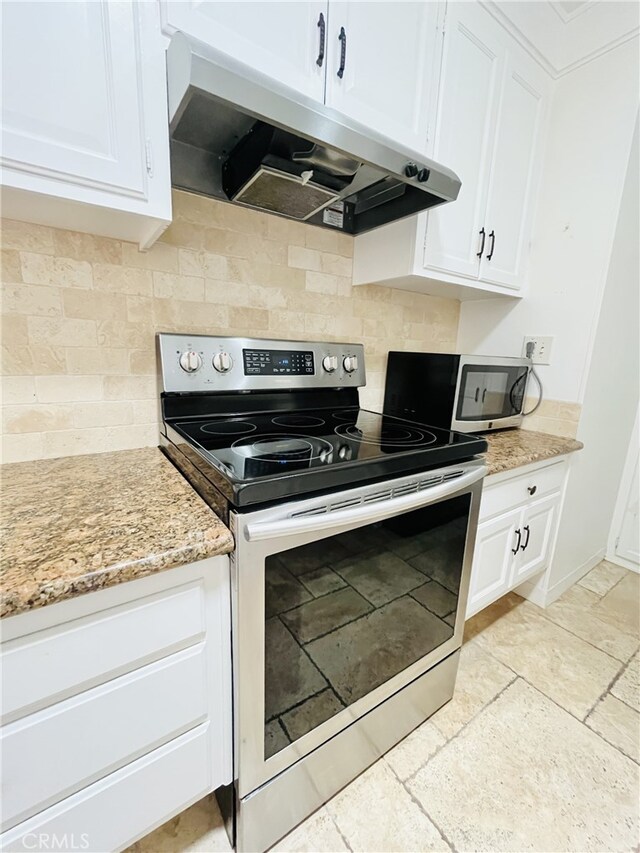 2019 Via Mariposa W Unit G, Laguna Woods, CA 92637 - kitchen with stainless steel electric range oven, under cabinet range hood, white cabinets, and decorative backsplash