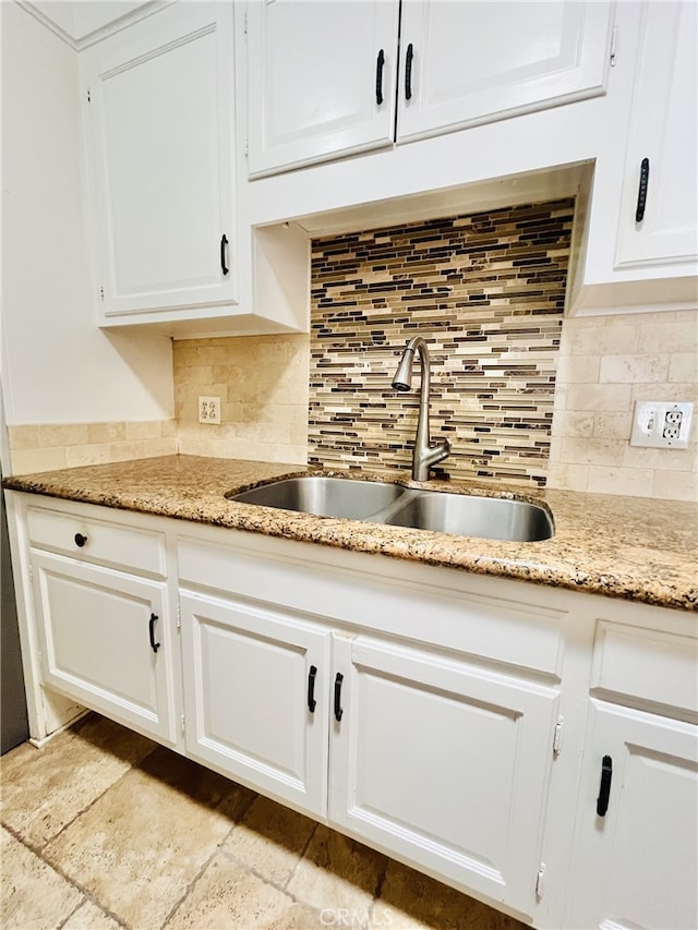 2019 Via Mariposa W Unit G, Laguna Woods, CA 92637 - kitchen with a sink, white cabinetry, decorative backsplash, and light stone counters