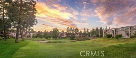 2019 Via Mariposa W Unit G, Laguna Woods, CA 92637 - surrounding community with a lawn and view of golf course