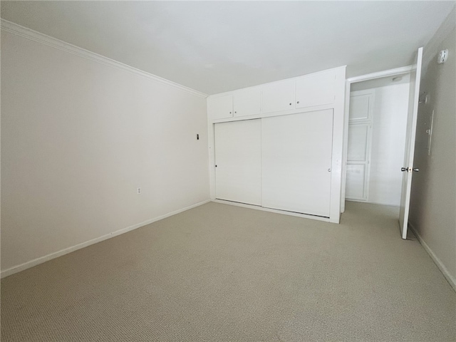 2019 Via Mariposa W Unit G, Laguna Woods, CA 92637 - unfurnished bedroom with light carpet, crown molding, baseboards, and a closet