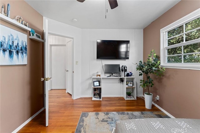 bedroom featuring wood finished floors, ceiling fan, and baseboards
