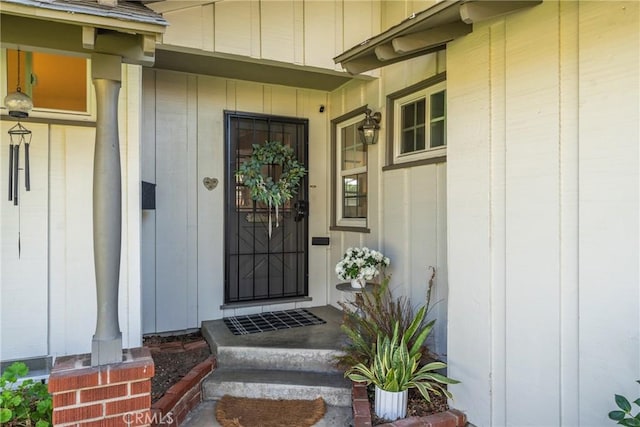 view of exterior entry featuring board and batten siding
