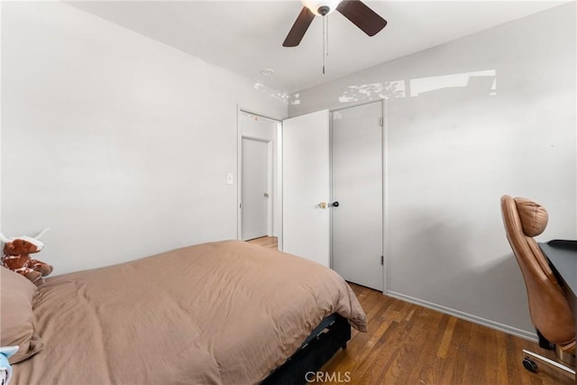 bedroom with wood finished floors, a ceiling fan, and lofted ceiling