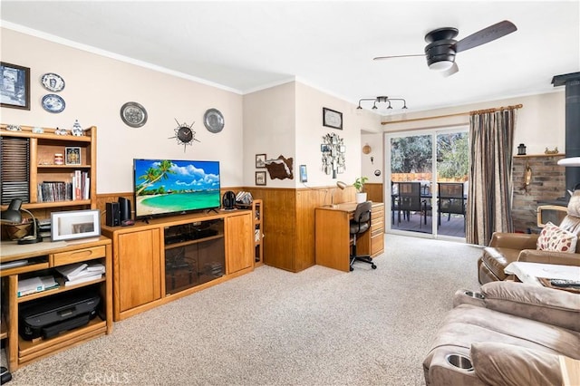 250 N Wateka St, San Jacinto, CA 92583 - living room featuring a wood stove, carpet flooring, crown molding, ceiling fan, and wainscoting