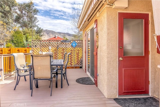 250 N Wateka St, San Jacinto, CA 92583 - deck with a mountain view, outdoor dining space, and fence