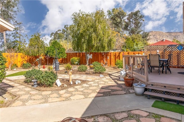 250 N Wateka St, San Jacinto, CA 92583 - view of patio featuring outdoor dining area, a deck with mountain view, and a fenced backyard
