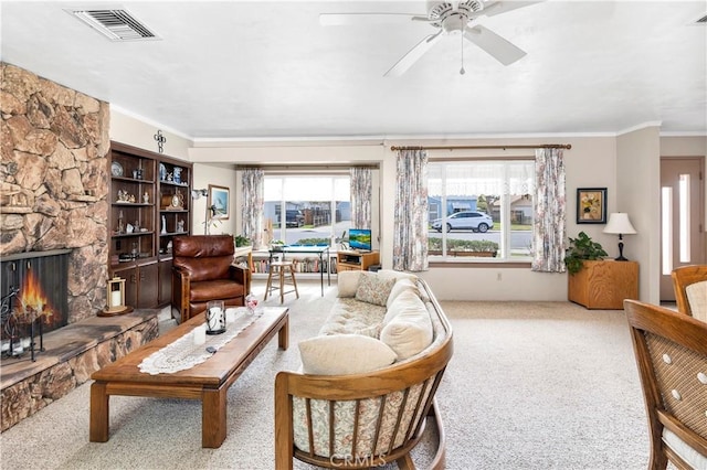 250 N Wateka St, San Jacinto, CA 92583 - living room featuring carpet, ornamental molding, ceiling fan, and a stone fireplace