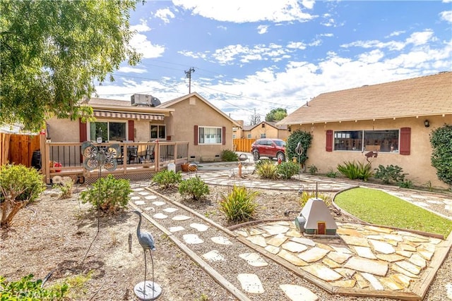 250 N Wateka St, San Jacinto, CA 92583 - rear view of property featuring a wooden deck, stucco siding, and fence