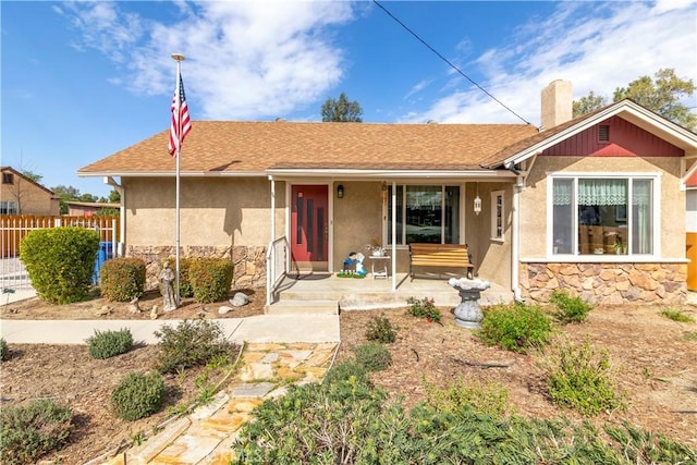 250 N Wateka St, San Jacinto, CA 92583 - ranch-style home with stone siding, covered porch, fence, and stucco siding