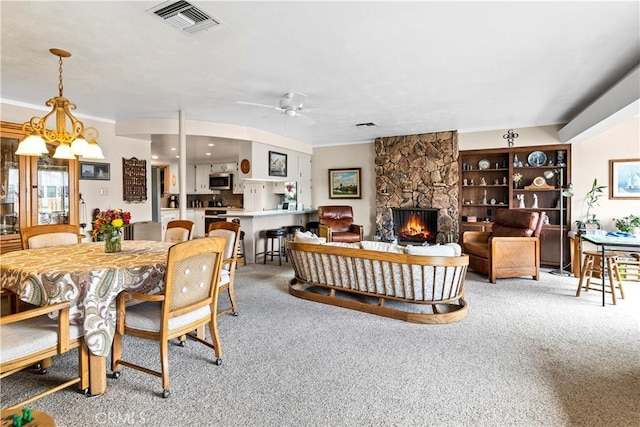 250 N Wateka St, San Jacinto, CA 92583 - dining room featuring a fireplace, carpet floors, ceiling fan, crown molding, and a chandelier
