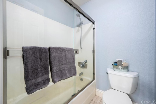 8731 Graves Ave Unit 13, Santee, CA 92071 - full bathroom featuring toilet, enclosed tub / shower combo, baseboards, and tile patterned flooring