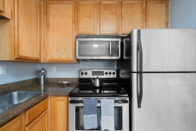 8731 Graves Ave Unit 13, Santee, CA 92071 - kitchen featuring stainless steel appliances, a sink, and dark stone counters