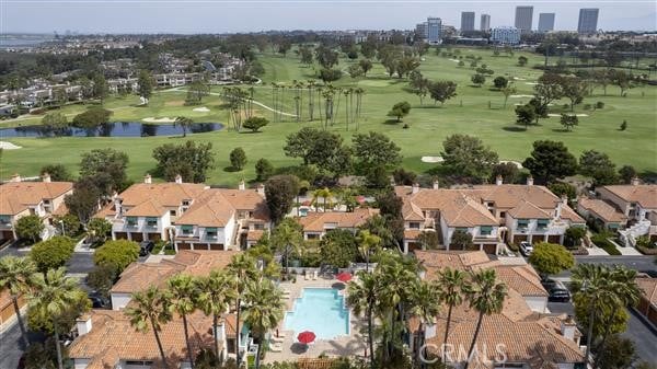 birds eye view of property featuring a water view, view of golf course, and a residential view